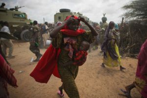 Somali women rush to a feeding centre after the soldiers of the Transitional Federal Government cannot contain the crowd in Badbado, an IDP camp. / Credit:UN Photo/Stuart Price